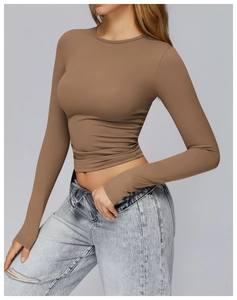 Detailed side view of fitted long sleeve yoga top in earth tone coffee brown