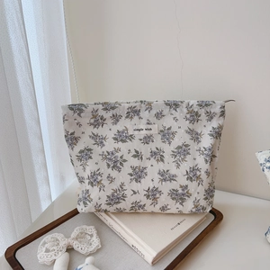 Close-up of floral cotton pouch with simple wish label and purple flower print