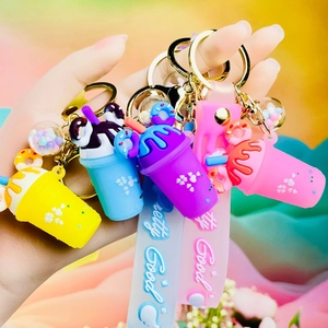 Close-up of four colorful beverage cup keychains with Pretty Good wrist straps