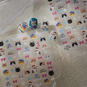 Detailed view of 5D embossed cat nail art stickers with cute floral and bow patterns