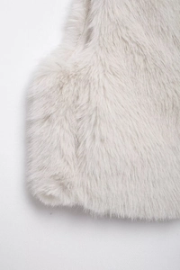 Close-up of light gray faux fur vest showing luxury texture on shoulder and chest