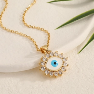 Gold evil eye necklace with blue enamel pendant and sparkling cubic zirconia stones
