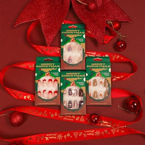 Christmas press-on nail kit with red French tips, gingerbread, and snowflake patterns