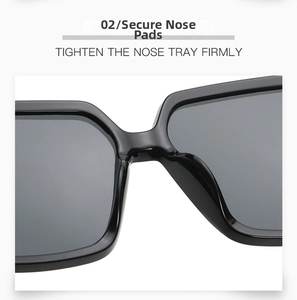 Detail of sturdy integrated nose bridge on square oversized glossy black sunglasses