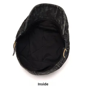 Detailed interior of washed denim flat cap showing premium fabric lining and metal buckle