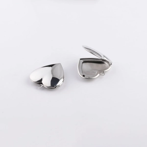 Close-up of polished 316L heart locket pendant in open and closed positions