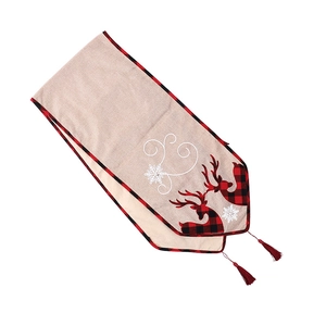 Christmas table runner with red reindeer silhouette, snowflakes, and festive tassels