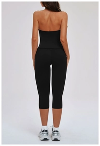 Back view of a black 3-piece yoga set featuring an open-back top and cropped leggings
