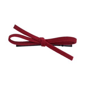 Elegant red suede bow hair clip with black metal fastener on a clean white background
