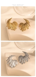 Detailed view of large metallic flower earrings with vertical texture in gold and silver