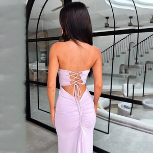 Detail view of backless light purple dress showing lace-up ties and ruched fabric texture