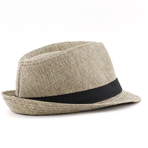 Close-up of the woven paper straw texture and black grosgrain band on the beige fedora hat