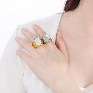 Detail of 18K gold and silver plated stainless steel ring with square white shell inlay