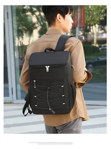 Outdoor shot of a black insulated cooler backpack showing large capacity and side mesh pocket
