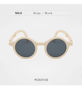 Front view of beige round frame sunglasses for kids with dark black lenses, NO.5 style