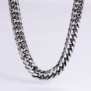 Macro view of polished thick silver stainless steel Cuban link chain with glossy finish