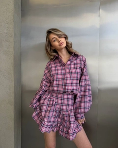 Detailed view of pink and blue plaid two-piece set with ruffled mini skirt