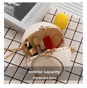 Internal view of a white spherical pearl bag showing space for lipsticks and gold chain
