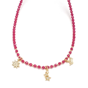 Detail of rose red beaded necklace with gold star and crown pendants with small diamonds