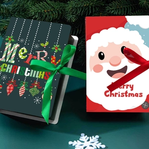 Detail of red and green Christmas magic book gift boxes with elegant silk ribbons