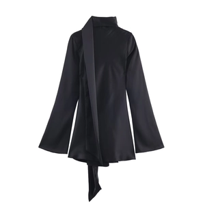 Detail of elegant black satin high neck blouse with silk-like texture and scarf collar