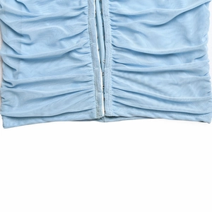Detail shot of light blue mesh dress with hook-and-eye closure and ruched fabric texture