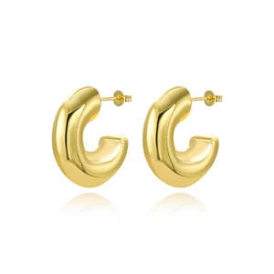 Close-up of thick C-shaped gold hoop earrings with mirror-like polished surface