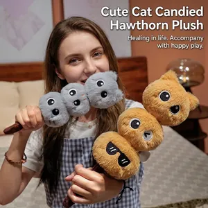 Creative plush cat skewer toy held by a model in a warm indoor bedroom setting