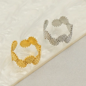 Minimalist adjustable stainless steel wave rings in gold and silver finish on marble