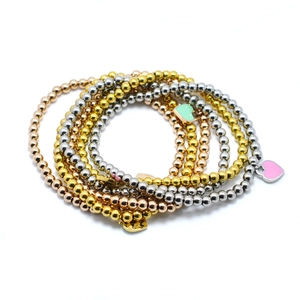 Three-piece 4mm beaded metal bracelets set with heart charms in gold, silver and rose gold