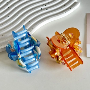 Elegant acetate 3D flower hair claws in blue marble and orange amber patterns