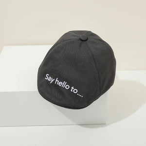 Detailed view of dark grey cotton baby beret featuring white Say Hello embroidery
