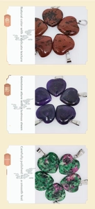 Detailed view of heart-shaped natural gemstone pendants with silver metal clasps
