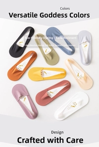 Flat lay of colorful no-show ice silk socks in nine vibrant colors with paper inserts