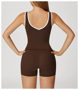Detail of cross high-waisted gym shorts and backless sports top in dark brown
