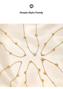 Detail of gold-plated butterfly and heart pendants with rhinestones on satin
