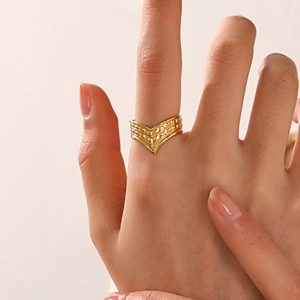 18K gold plated V-shaped stainless steel ring with geometric textures worn on index finger