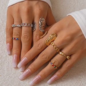 Close-up of rings with lava texture and colorful zircons on a model's hand