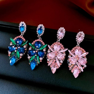 Detailed close-up of water drop earrings with vibrant blue and pink crystal rhinestones