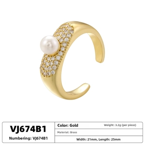 Detail of gold floral open ring with white pearl, pavé crystal setting and 3.2g weight
