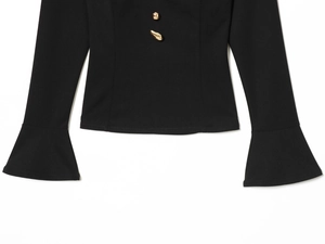 Detail of black long sleeve top with flared cuffs and stylish gold metal buttons