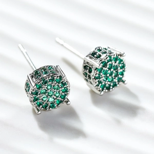 Silver round earrings with green micro-paved cubic zirconia in a hip hop style