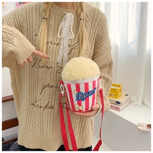 Crossbody bag in a creative popcorn bucket design with red and white stripes and plush top