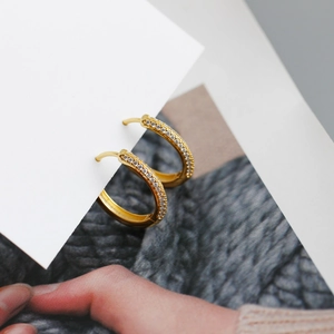 Close-up of gold plated S925 sterling silver hoop earrings with micro pavé cubic zirconia