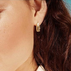 U-shaped minimalist 18k gold plated stainless steel chunky earrings on a model