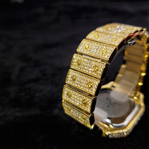 Macro shot of gold-plated watch strap with sparkling crystals and decorative screws