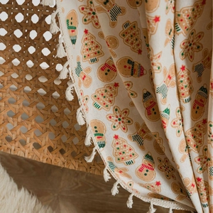 Beige Christmas gingerbread man curtain with festive prints and white cotton tassels