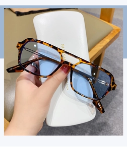 Fashionable tortoise shell sunglasses with blue lenses and a double-bridge frame design
