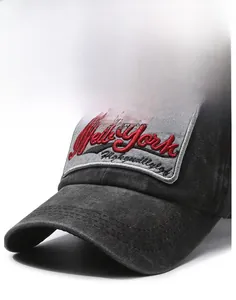 Detail shot of the curved brim and red New York embroidery on a washed black cotton cap