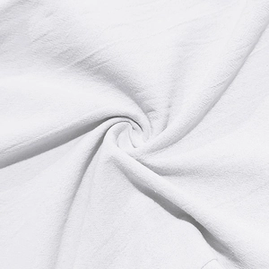 Macro shot of white cotton linen fabric showing breathable woven texture and fiber detail